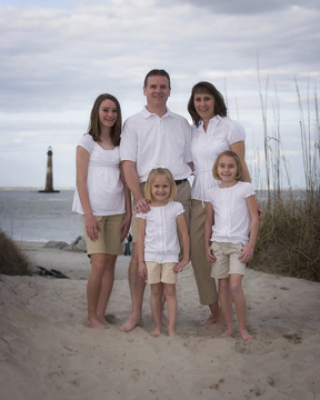 family beach portrait overlooking Folly Beach lighthouse